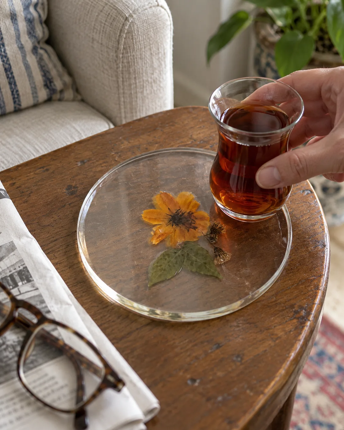 Marigold tea coaster with a glass of tea
